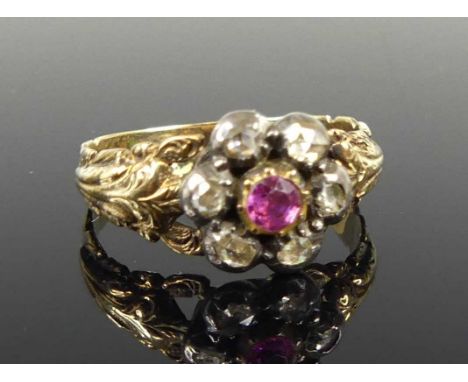 A George III yellow and white metal ruby and diamond circular cluster ring, the centre round ruby within a border of 6 rose c