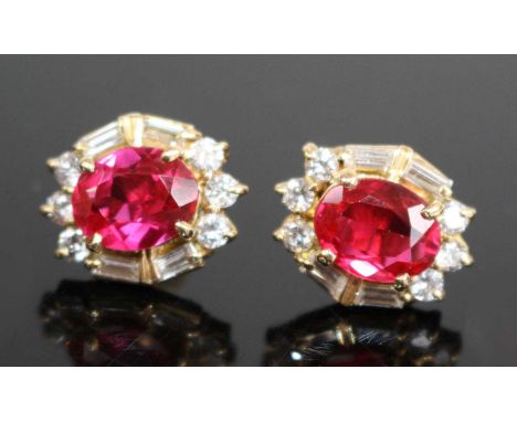 A pair of yellow metal synthetic ruby and diamond oval cluster earrings, each comprising a centre synthetic ruby within a bor