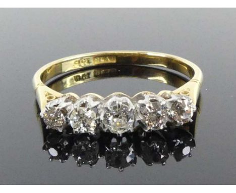 A yellow and white metal diamond five-stone half eternity ring, comprising five graduated Old European cut diamonds in claw s