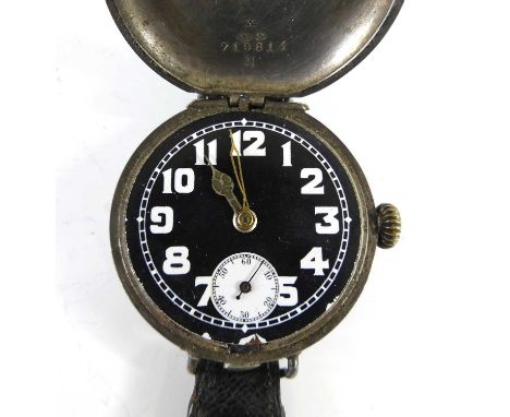 A First World War period Rolex trench watch, of full hunter type, the silver cover opening to reveal a black enamel dial whit