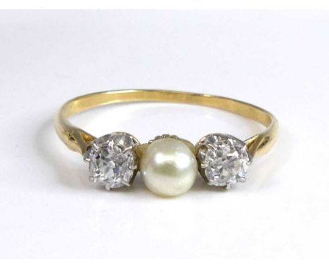 A yellow and white metal pearl and diamond 3 stone ring featuring a centre 4.35mm cultured pearl flanked by an old European c