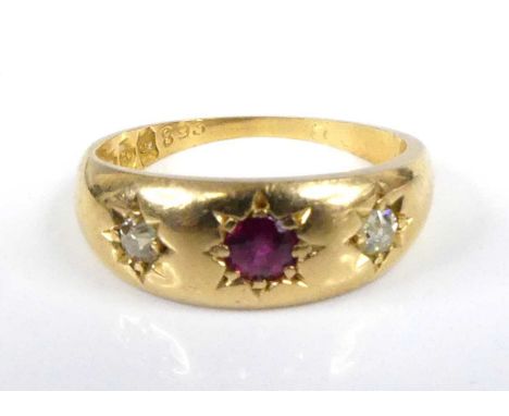 An 18ct yellow gold, ruby and diamond dress ring, comprising a centre round ruby and two Old European cut diamonds, all in gy