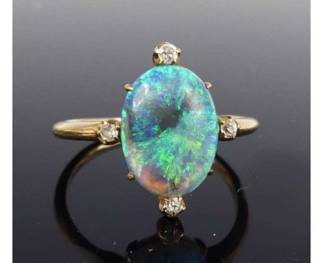 A rose metal opal and diamond dress ring, the oval opal cabochon surrounded by 4 old European cut diamonds at compass points,