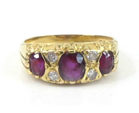 An 18ct yellow gold, ruby and diamond half eternity ring, featuring three graduated oval rubies interspersed with four single