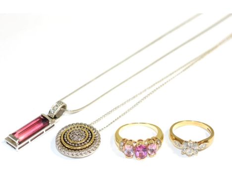 A pink tourmaline and diamond pendant, a baguette cut pink tourmaline in a rubbed over setting, suspended from a diamond set 