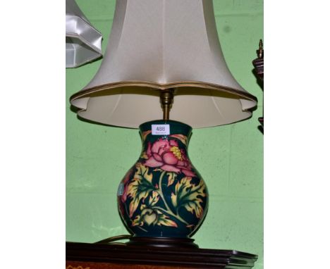 A Moorcroft table lamp decorated with pink flowers on a green ground, 28cm (excluding fitting)