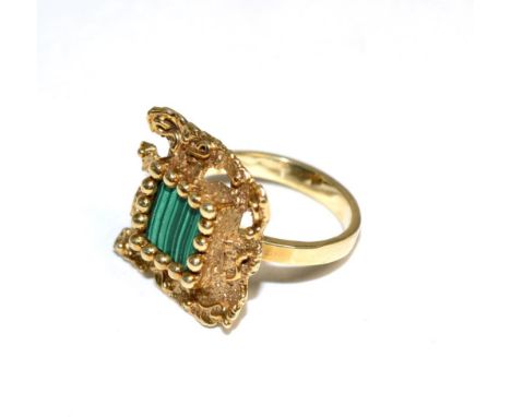 A malachite ring, a square malachite plaque in a beaded claw setting, within a textured square frame, finger size K The ring 