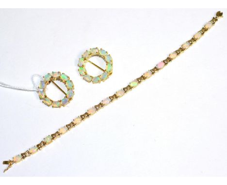 A 14 carat gold opal bracelet, oval cabochon opal links spaced by X-shaped links, length 18cm and two 9 carat gold opal hoop 