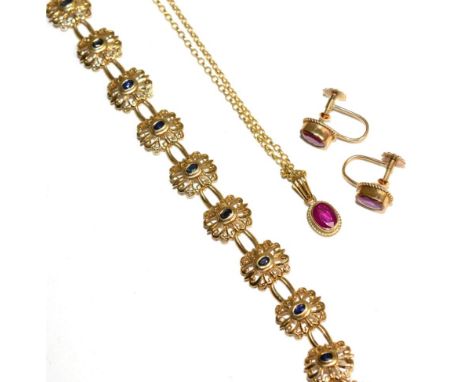 A 9 carat gold ruby pendant and earring suite, an oval cut ruby in a rubbed over setting, within a rope frame, the pendant on