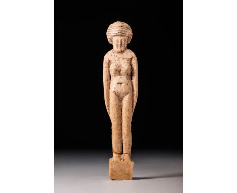 Late Period or earlier, Ca. 664 - 332 BC.A female figure carved from bone. She stands in an upright position atop a rectangul