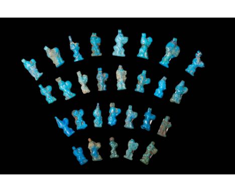 New Kingdom, Ca. 1550 - 1069 BC.A collection of 28 blue faience amulets. Each amulet depicts Bes, the dwarf god, playing a ta