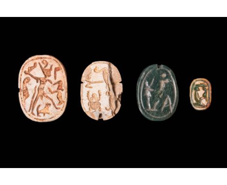 Ca. 2055 - 30 BC.A collection of four scarabs with ovoid body, carved from steatite and green stone and presenting pleasingly