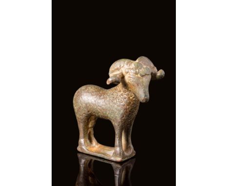 Ca. AD 100 - 300.A Roman bronze figurine of a ram. The ram is standing with carved detail in the coat and curved horns. Rams,