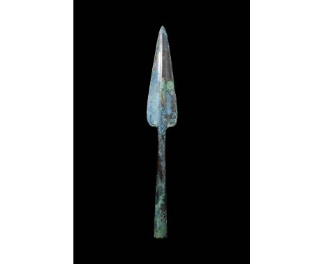 Ca. 1200 - 800 BC.A Bronze Age spearhead with a pronounced central rib, a triangular blade, and a hollow conical shaft. For s