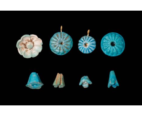 New Kingdom, Ca. 1550 - 1069 BC.A collection of eight faience flower-shaped amulets including one eight-petalled flower amule