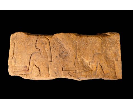 New Kingdom, Ca. 1550 - 1069 BC.An incredible Egyptian limestone rectangular stele carved with elaborate figures. The main sc