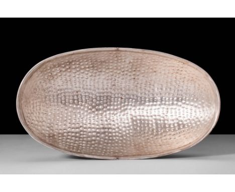 Ca. AD 200 - 600.A Sassanian bowl of lustrous silver hues with an elliptical form. The vessel is embellished with protruding 