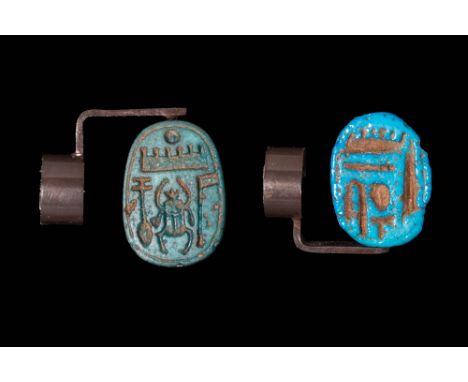 18th Dynasty, Ca. 1450 - 1300 BC.A pair of scarabs crafted from faience, each featuring a drilled hole. The first is made of 