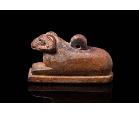 Ca. 664 - 30 BC.A brown faience amulet in the form of a mummified ram in a recumbent pose on an integral rectangular plinth. 