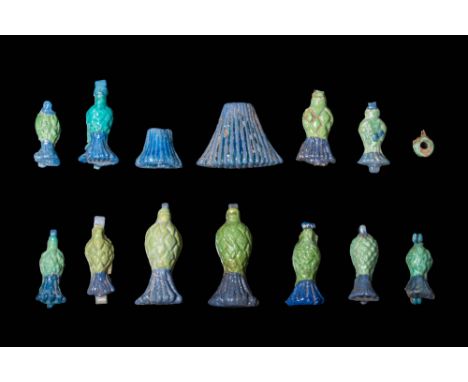 New Kingdom, Ca. 1550 - 1069 BC.A collection of 14 cornflower-shaped pendants. Bichrome faience pendants in shades ranging fr