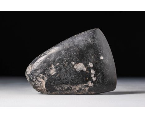 Ca. 5000 - 4000 BC.A stone axe head crafted from pecked and polished stone, characterised by a broad and sharp cutting edge. 
