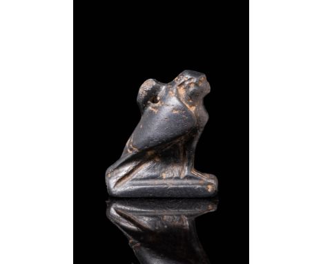 Ca. 664 - 30 BC.A small amulet carved from black hardstone depicting the god Horus in the shape of a falcon. The dignified fa