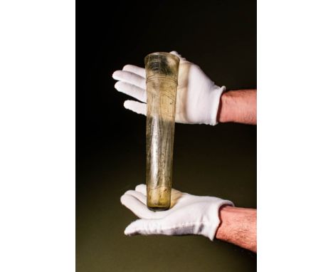 Ca. AD 475 - 550 .A cone-shaped beaker made of pale green glass. The body is decorated with a horizontal spiral on the upper 