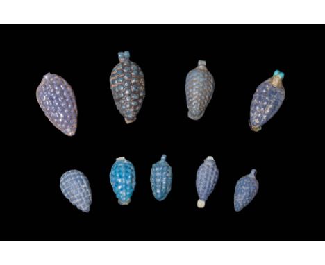 New Kingdom, Ca. 1550 - 1069 BC.A collection of nine faience amulets. Each amulet is formed as a tapered bunch of grapes with