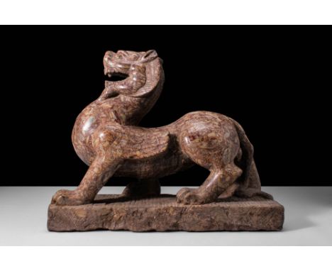 Ca. 202 BC - AD 220.A puddingstone carved sculpture of a dragon. The lively figure is mid-motion roaring, with its head held 