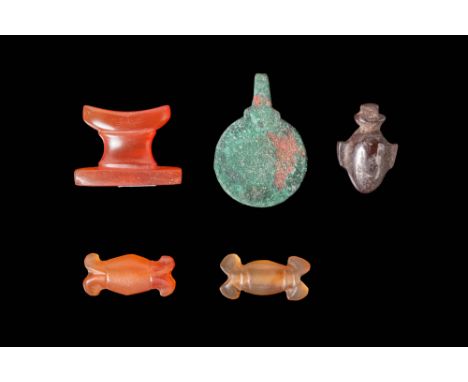 Ca. 664 - 30 BC.A collection of three faience and stone amulets. The first is a carnelian headrest amulet. The second is a br