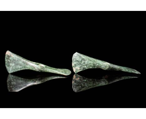 Ca. 1200 - 800 BC.A pair of finely moulded Western Asiatic cast bronze double axe heads with vertical and horizontal blades. 