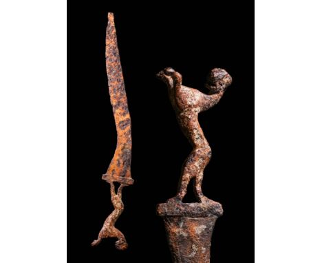 CA. 100 BC.A curved, single-edged iron sword, possibly a machaira or a sica. The weapon sweeps downward and the handle is in 