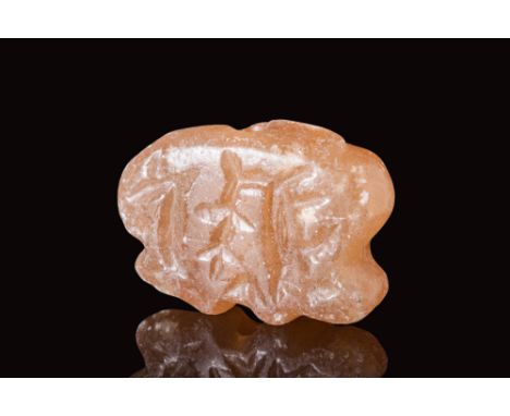 Ca. 3000 - 2500 BC.A Mesopotamian orange stone amulet depicting animals. It is drilled vertically.Size: 28mm x 18mm; Weight: 