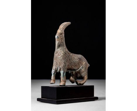 Ca. 500 - 300 BC.A Greek figurine of a walking goat. The goat is standing on four legs with carefully striated long hair and 