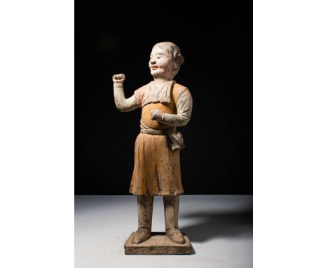 Ca. 618-906 AD.A Tang dynasty terracotta figure of a foreigner. His hair braided neatly in the back, he is wearing a knee-len