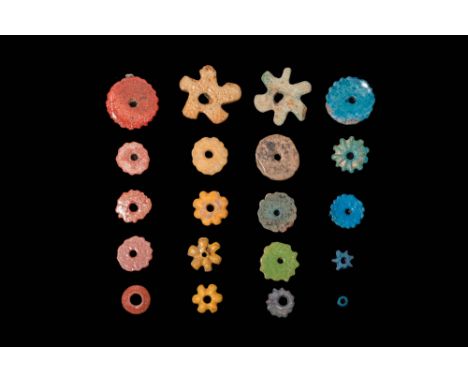 New Kingdom, Ca. 1550 - 1069 BC.A collection of 20 decorative beads exhibiting a range of colours, including red, orange, bei