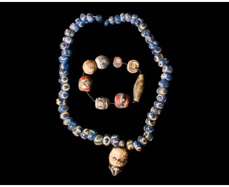 Ca. 500 - 300 BC. A set of Phoenician wearable glass beaded necklace and bracelet. The necklace is composed of dozens of glob