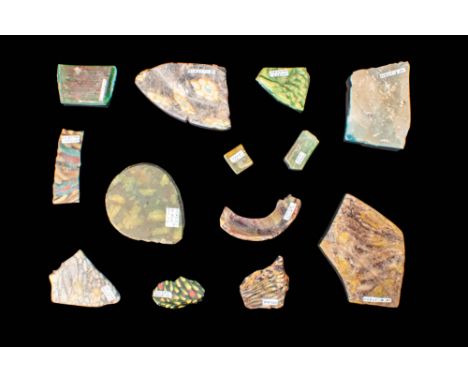 Ca. 100 BC - AD 200.A set of 13 mosaic glass inlays, featuring various shapes and multicoloured decorations. These inlays are