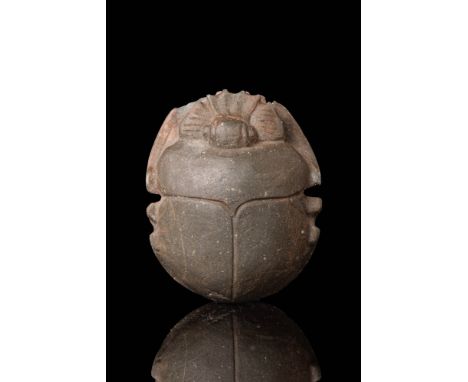 Late Period, Ca. 664 - 332 BC.A scarab with an ovoid body, carved from green/black stone presenting pleasingly smooth surface