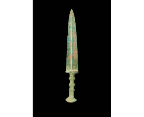 Ca. 1200 - 800 BC.A Western Asiatic moulded bronze dagger with a short, tapering blade, a prominent with mid-rib and a guard.