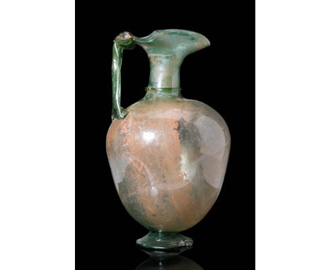 Ca. AD 300 - 500.A lovely Roman mold-blown translucent glass oinochoe with a round base, a globular body and a rounded should