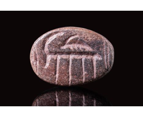 Ca. 3100 - 2900 BC.A rare stamp seal, carved using drilling and string cutting. It is made from a piece of red opaque stone a