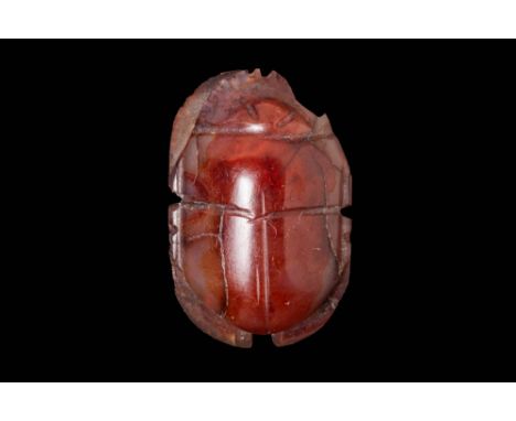 Ca. 664 - 332 BC.A scarab with an ovoid body, carved from carnelian, presenting pleasingly smooth surfaces. The topside of th