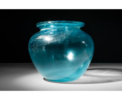 Ca. AD 50 - 200.A Roman hand-crafted blue translucent glass cinerary urn. The urn exhibits a broad apple-shaped body, a sligh