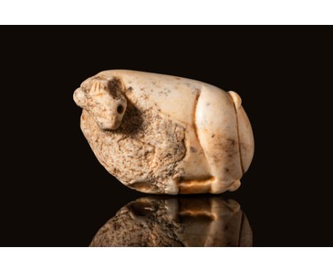 Ca. 3000 BC.A Mesopotamian white marble stamp seal drilled vertically. The front depicts a small recumbent animal with large 