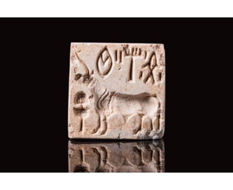 Ca. 2300 BC.An Indus Valley white stone stamp seal. This is a square plaque with a suspension loop of one piece on the back. 