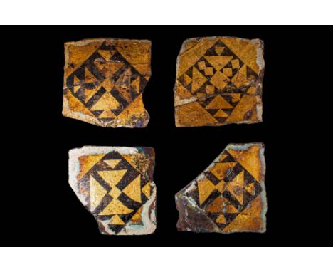 Ca. AD 1000 - 1200.A collection of four square sandwich glass tiles featuring gold and black geometric motifs. They have a ce
