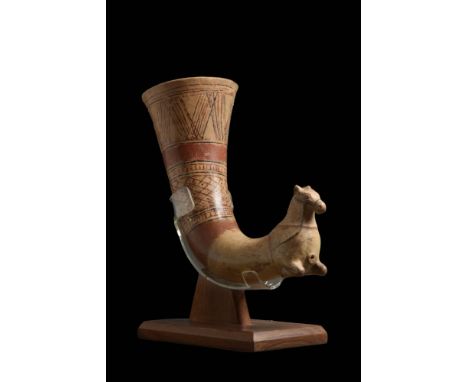 Ca. 400 - 300 BC.A terracotta rhyton with a flaring lip and a conical shaped body terminated into an equine finial. The trump