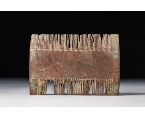 Ca. 100 BC - AD 100.A wooden comb with central large flat section part and very fine teeth. Combs were important in the ancie