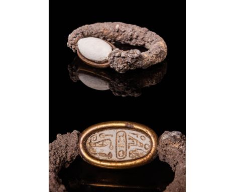 Ca. 664- 30 BC.A silver ring with a scarab, featuring a D-shaped body formed of a round-sectioned shank. The ring includes an